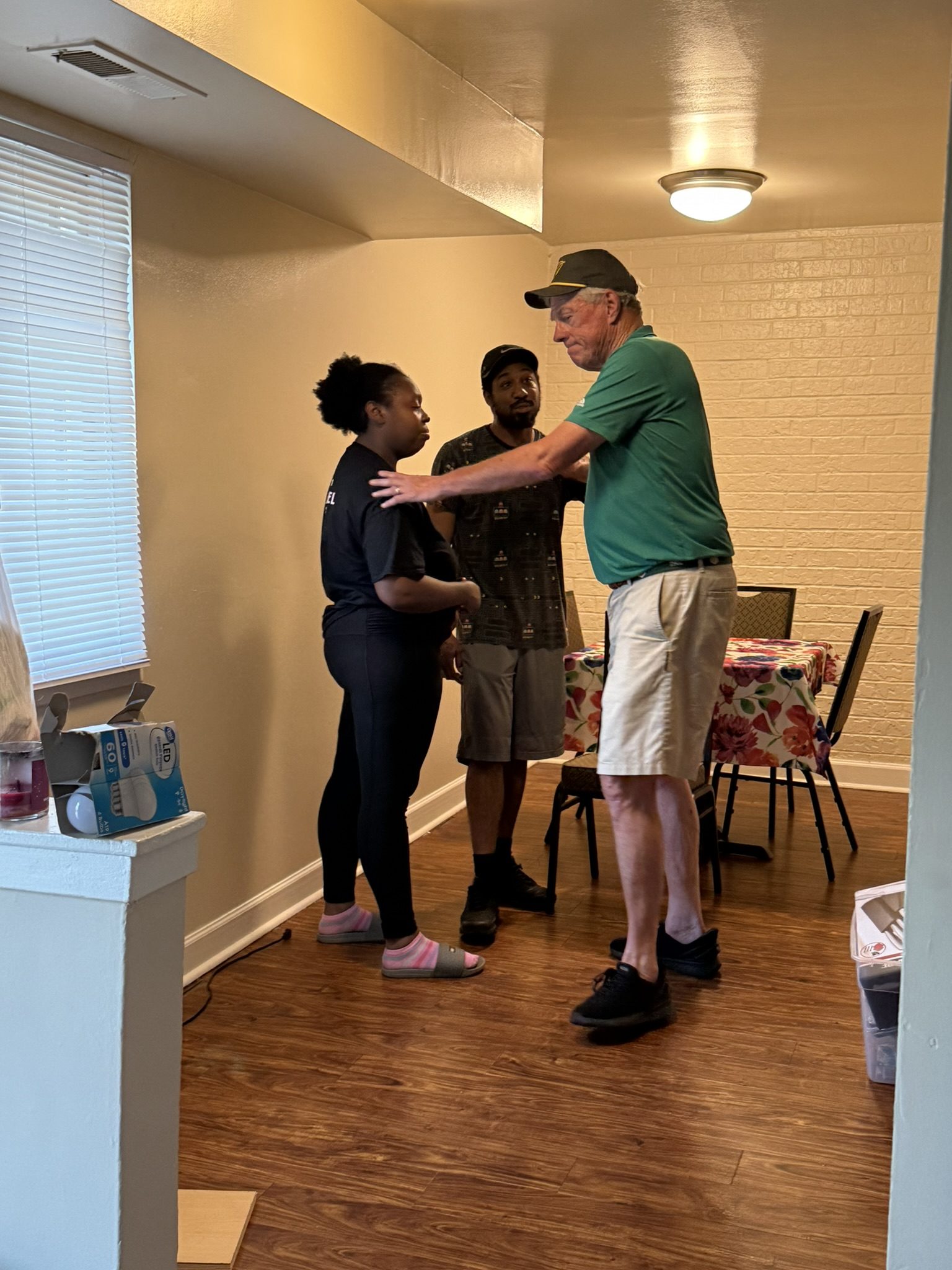 An OTS Rockville volunteer embraces a family member in their newly furnished home