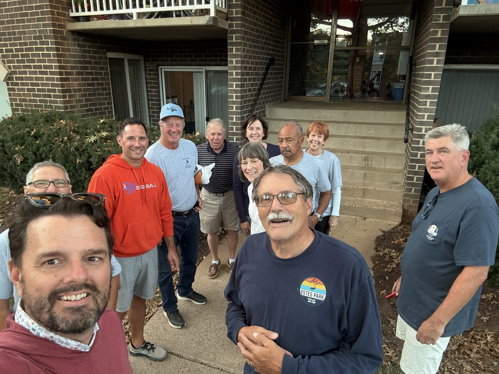 A group of OTS Rockville volunteers gathered at an apartment building before a delivery