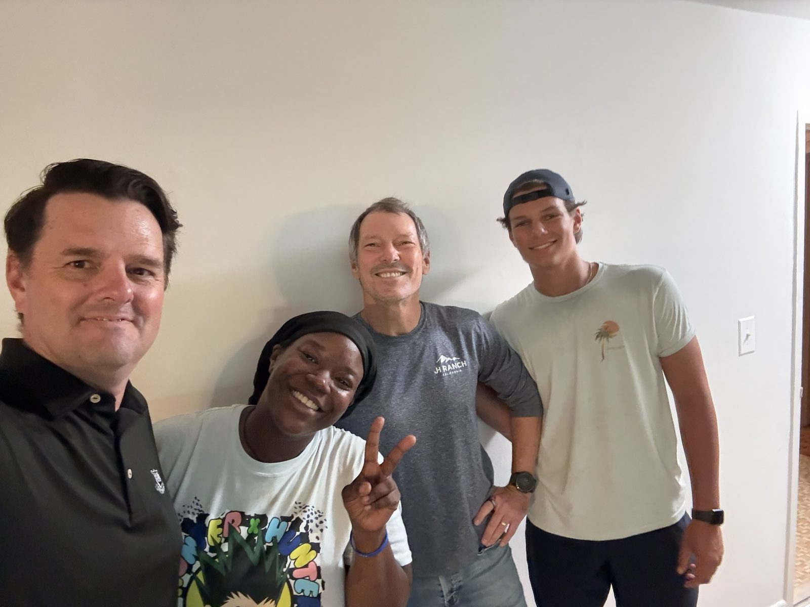 OTS Rockville volunteers and a family member smiling together in a newly furnished home