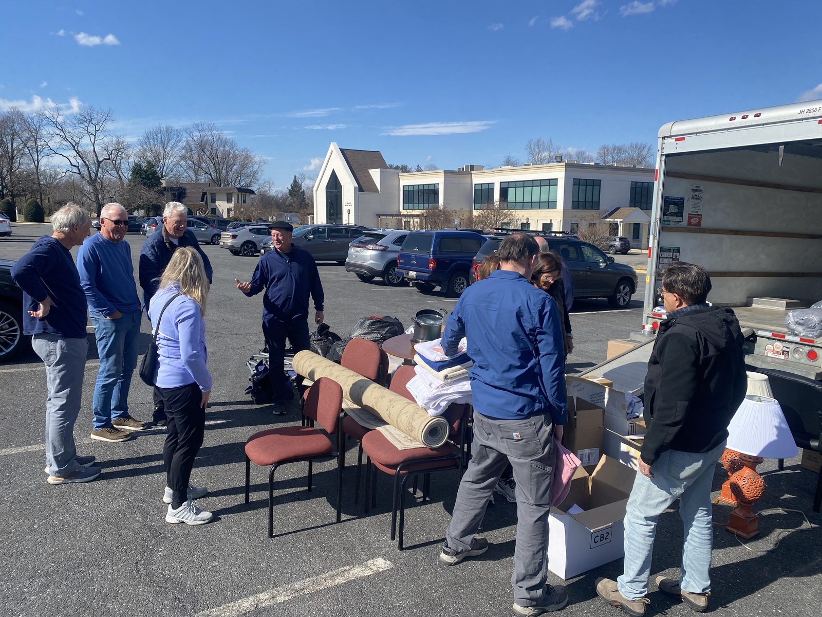 OTS Rockville volunteers gathered around boxes of donated items