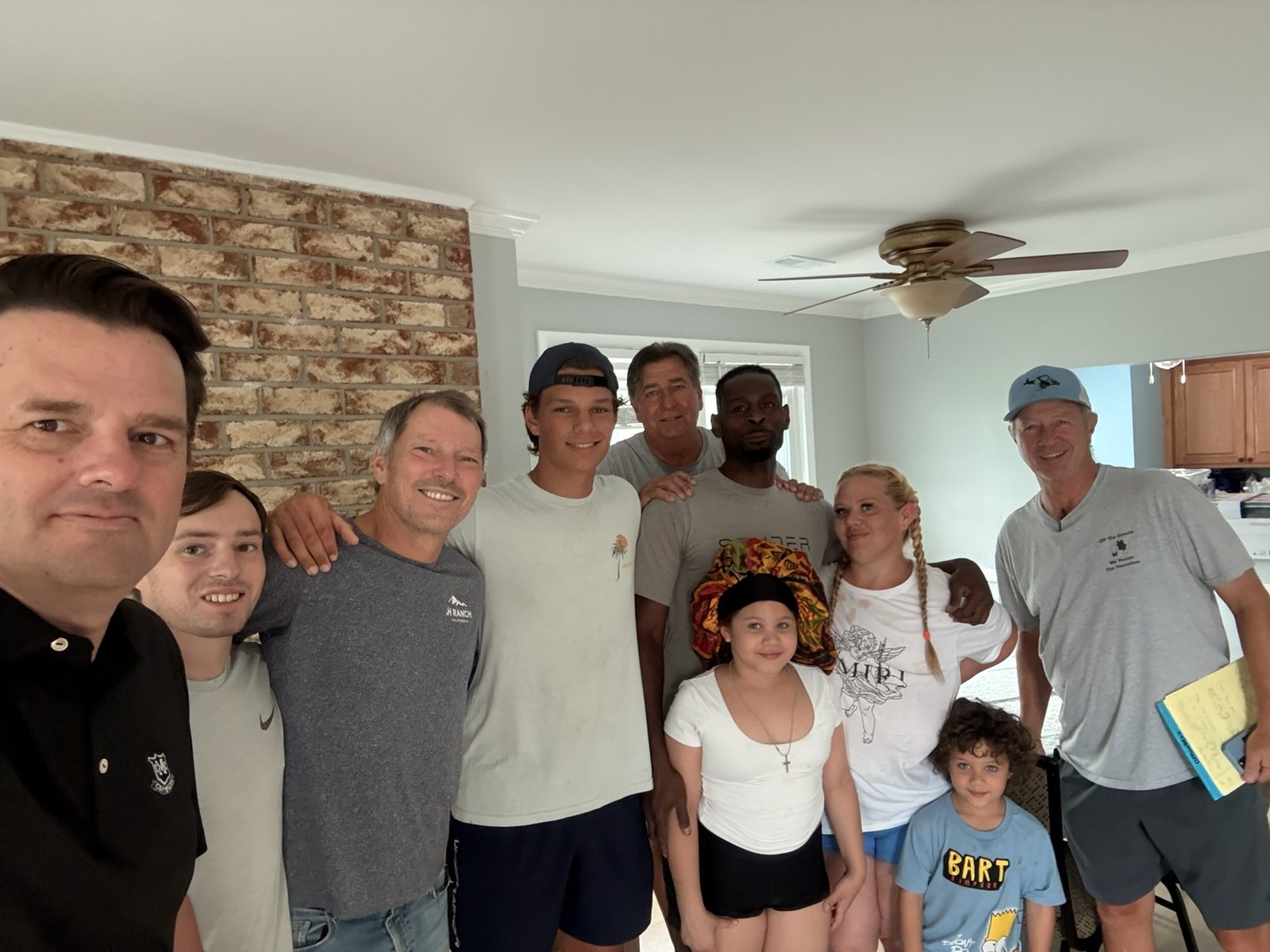 OTS Rockville volunteers and a family posing together in the family's newly furnished home